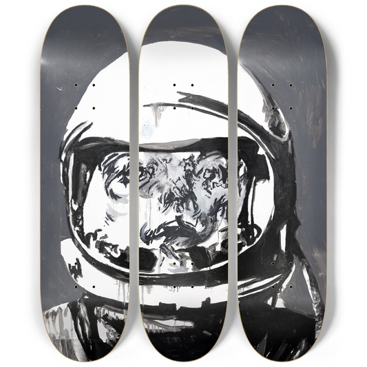 Three aligned skateboard decks featuring the full "Space Man" artwork by Justin Chapman — a monochrome astronaut figure forming a continuous triptych.